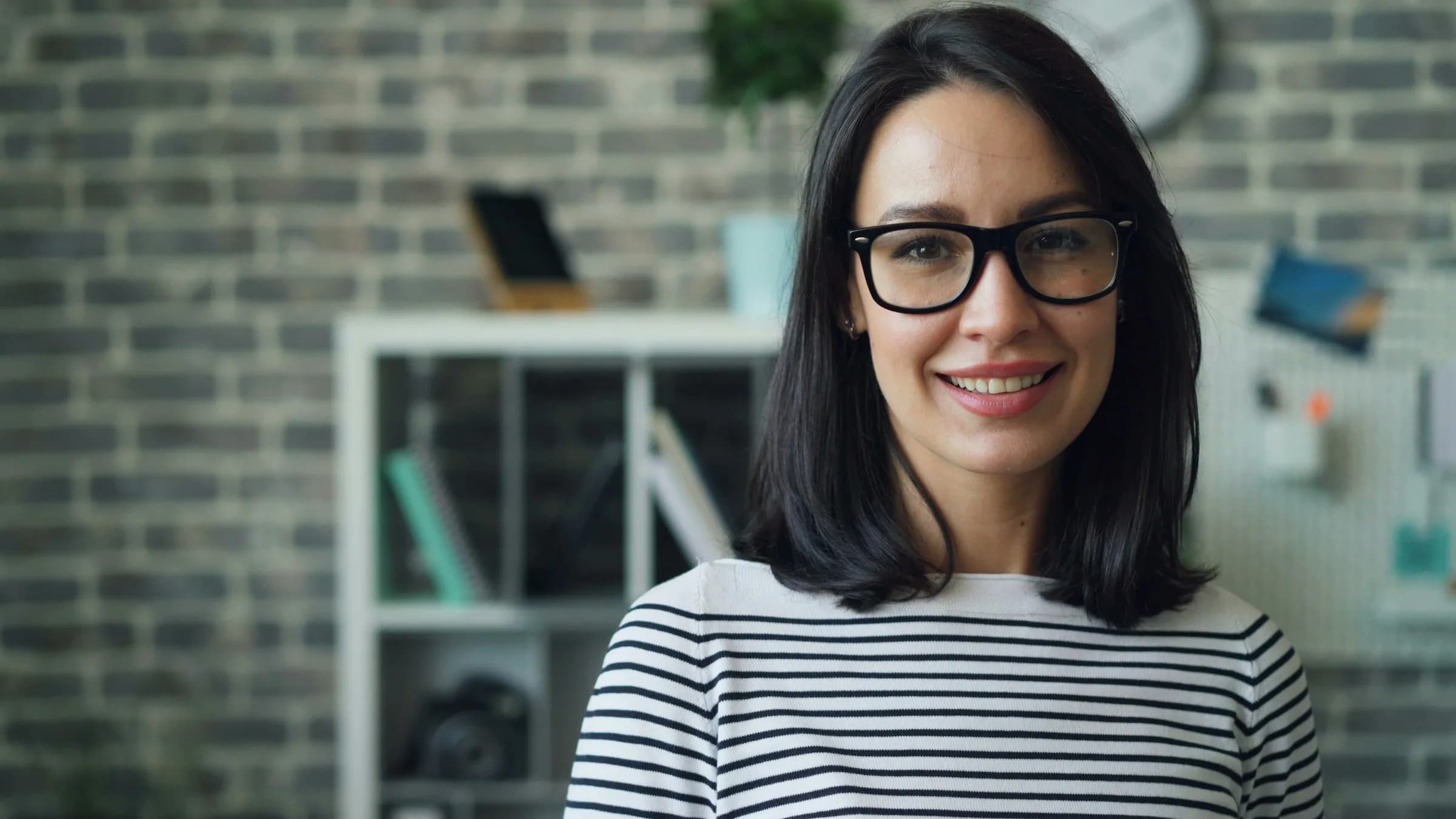 Advisor with glasses smiling in her office